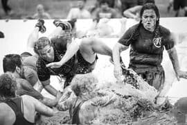 Chrissy powering through the mud at a Tough Mudder obstacle race